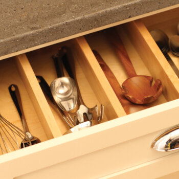 A kitchen organization idea with adjustable drawer partitions for creating adaptive storage.